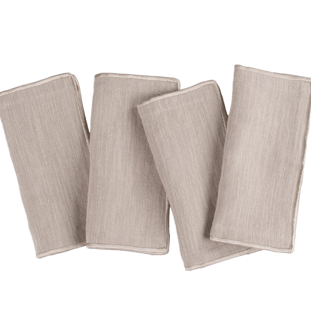 Four beige napkins on a white background